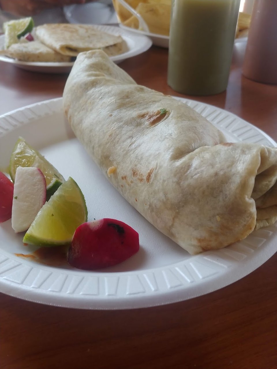 Assorted Mexican entrees served on colorful plates.